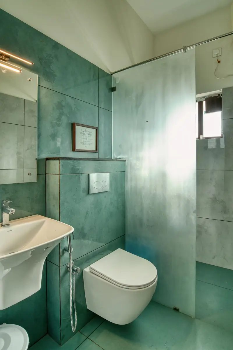 Bathroom with green stone walls and a wall-hung basin