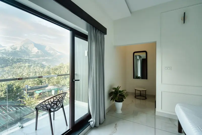 Bedroom 1 with a king bed and glass doors to a hill-view balcony