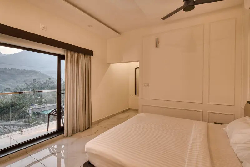Warm-lit bedroom with balcony doors