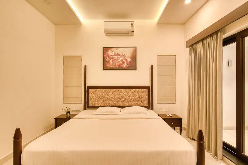 Bedroom with a carved headboard in warm light