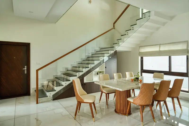 Dining table for eight beside the glass staircase