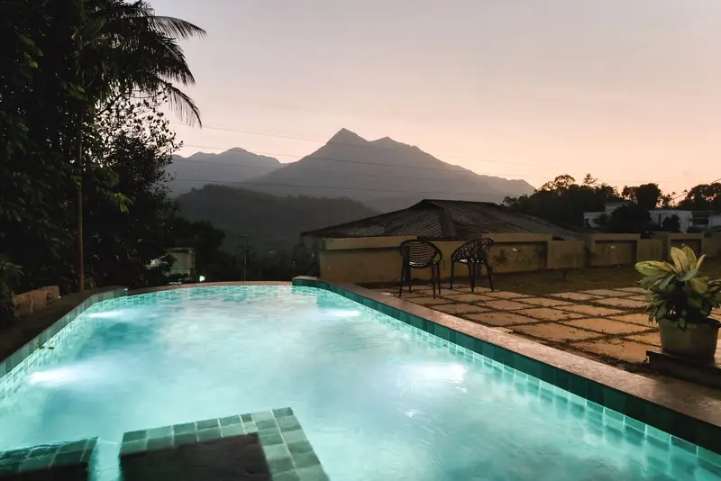 The same pool at dusk under a pink sky