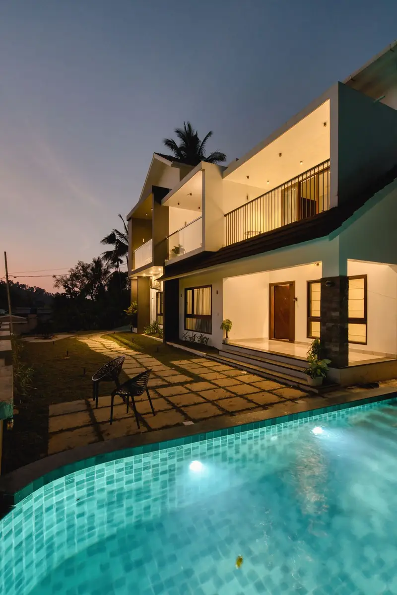 The villa and its pool lit up at night